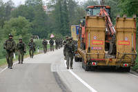 Polish soldiers pass through barricades as they patrol near a northern Kosovo border crossing.