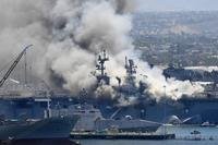 smoke rises from the USS Bonhomme Richard at Naval Base San Diego