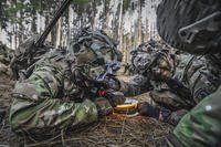 Paratroopers react after detonating a brazier charge.