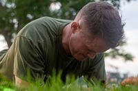 A Marine performs a front plank during a physical fitness test.