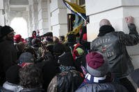 Insurrectionists try to open a door of the U.S. Capitol