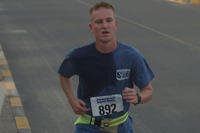 Marine Cpl. Shane Quinn pushes through the early morning heat during the Peachtree in Kuwait Fun Run at Camp Arifjan, Kuwait.