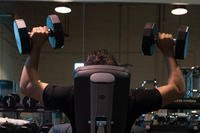 A soldier works out with dumbbells at Fort Bragg.