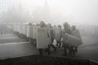 Riot police walk to block demonstrators during a protest in Almaty, Kazakhstan