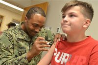 A hospital corpsman gives a vaccine at Naval Hospital Jacksonville’s Immunizations Clinic.