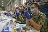 Medical personnel prepare COVID-19 vaccinations.