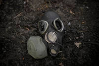 A damaged gas mask lies on the pavement outside Kyiv, Ukraine.