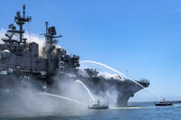 San Diego Harbor Police boats fight a fire aboard the USS Bonhomme Richard.