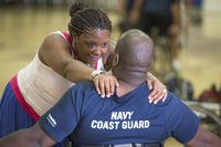 Shundra Johnson, left, gives encouragement to her husband Coast Guard Lt. Sancho Johnson during the Navy’s wounded warrior training camp for the 2015 DoD Warrior Games in Port Hueneme, Calif., May 29, 2015. Shundra is also her husband’s caregiver.