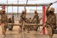 Marine recruits conduct a supply run as part of the crucible. 