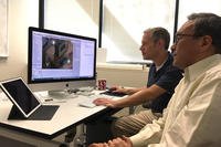 John Lee, right, and Alan Koenig, center, of the National Center for Research on Evaluation, Standards and Student Testing (CRESST), test a video game within the Navy Life online platform.