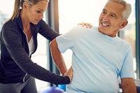 Older man receiving physical therapy