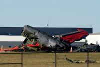 A damaged plane sits at the Dallas Executive Airport after two historic military planes collided.