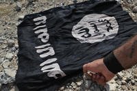 ISIS flag on the front line on the western side of Raqqa, northeast Syria.
