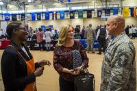 Brittany Moore, left, senior recruiter for a local hardware company, speaks to Senior Master Sgt. Jeremy Carlock, 23d Maintenance Group self-assessment program superintendent, right, and his wife, Shana, during a veterans career fair at Moody Air Force Base, Georgia.