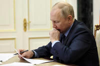 Russian President Vladimir Putin chairs a meeting.