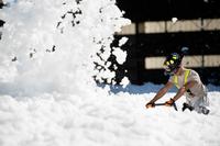 Airman blows a small sea of fire retardant foam.