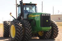 A squadron commander drives a John Deere tractor at the rodeo grounds during a farm tour as part of Farm City Week at Altus Air Force Base, Oklahoma.