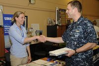 Naval Air Crewman 1st Class Matt Jolley shakes hands with Adrienne Hart, a representative from the URS Corporation, after receiving information during a career and education fair held at NAS Whidbey Island, Washington.
