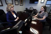 Meloney Perry, left, of Perry Law talks with a member of her staff, attorney Karla Roush, at Perry's law firm in Dallas. 