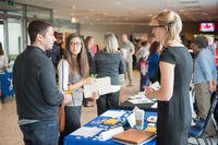 U.S. Air Force Tech. Sgt. Cody Andrews and his wife Paula talk with Eva Tukarski, head of the European Recruiting Office of a military placement firm, during the Employment and Career Expo at SHAPE, Belgium.