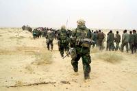 U.S. Marines escort captured enemy prisoner in Iraq.
