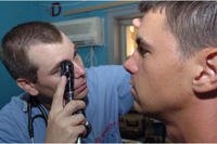 Connecticut National Guard Capt. David M. Lang, a certified physician assistant, examines a patient on LSA Anaconda in Balad, Iraq.