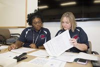 Human resource specialists review resumes for security guard positions during a job fair on Joint Base Pearl Harbor-Hickam.