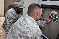 Senior Airmen Edgar Denard and Jonathan Pears, 8th Civil Engineer Squadron heating, ventilating, air conditioning and refrigerating technicians, adjust system controls on Kunsan Air Base, 26, South Korea.