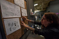 Senior Airman Autumn Rosado, 9th Aircraft Maintenance Unit avionics technician, adds a tattoo idea to a board at the Sacred Art tattoo shop in Abilene, Texas.