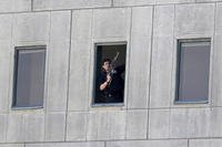 armed man stands in a window of the parliament building during an attack by militants in Tehran, Iran