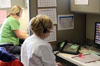 Registered nurses answer calls at a VA facility.