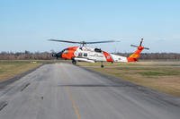 Coast Guard Air Station New Orleans MH-60 Jayhawk aircrew hovers over an airstrip