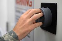U.S. Air Force information system security officer operates a lock