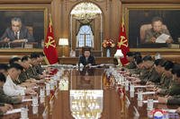 North Korean leader Kim Jong Un, center, attends a meeting