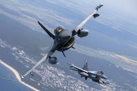 Romanian Air Force F- 16s military fighter jet, left, and a Portuguese Air Force F- 16s military fighter jets
