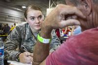 Airman performs health assessment on homeless person