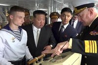 North Korea's leader Kim Jong Un listens to Russian Navy Admiral Nikolai Yevmenov.