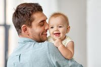 A father holds his baby.