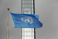The UN flag flies on a stormy day.