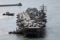 U.S. nuclear-powered aircraft carrier USS Ronald Reagan is escorted as it arrives in Busan, South Korea