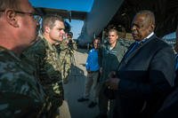 Secretary of Defense Lloyd J. Austin III speaks to U.S. Air Force airman delivering munitions to Nevatim Air Base, Israel