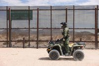 A Border Patrol agent watched a section of the wall at the border with Mexico in Sunland Park