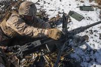 U.S. Marine reloads a .50 caliber machine gun during an exercise