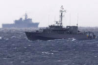 A Japanese Maritime Self Defense Force minesweeper searches in the waters.