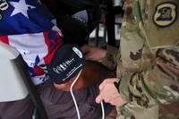 A medic checks the blood pressure of a veteran