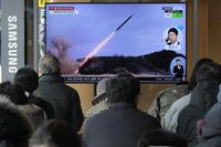 A TV screen shows a file image of North Korea's missile launch