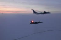 A Russian Tu-142 maritime reconnaissance aircraft is intercepted near the Alaska coastline.