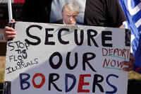 Phill Cady holds a sign during a &quot;Take Our Border Back&quot; rally