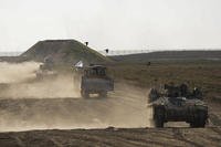 Israeli troops move near the Gaza Strip border in southern Israel